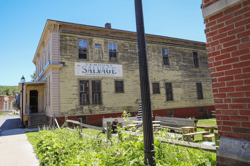webimage-WhiteRiverJunction115 The vermont Salvage Building in White River Junction - a yellow warehouse-style building with peeling paint.
